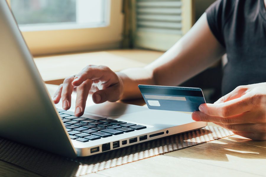 Make a Payment - Person Using a Credit Card to Pay for Insurance