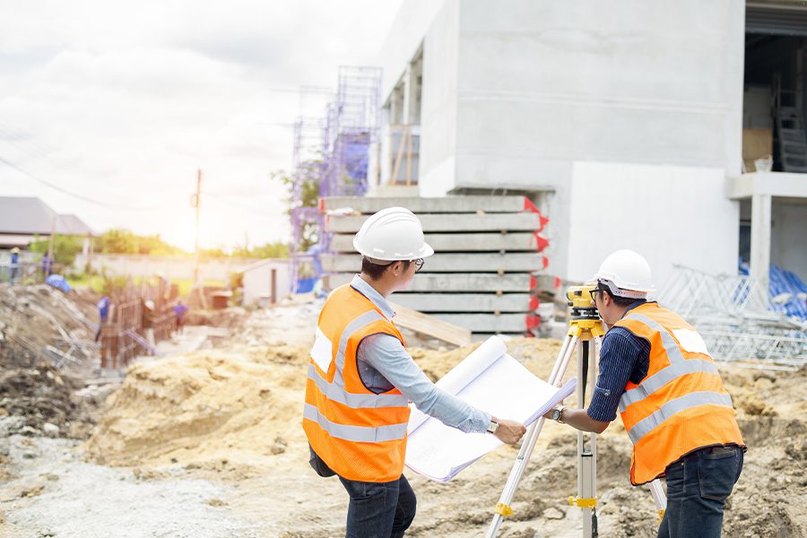 Specialized Business Insurance - Construction Engineer and Foreman Worker Checking a Construction Site Project